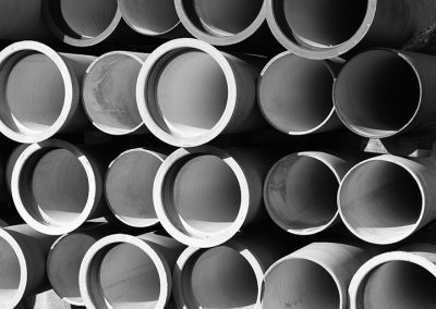 A bunch of pipes stacked together in a pile.